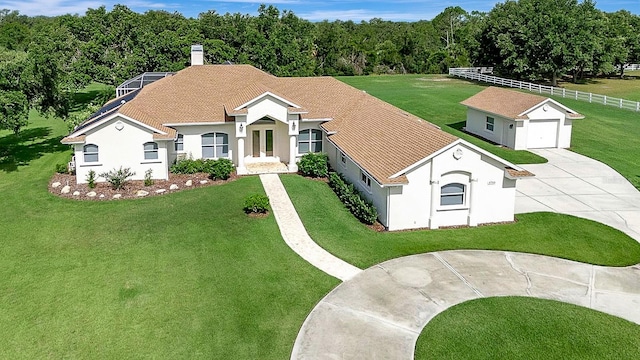 5750 Saddle Oak Trl, Sarasota, FL 34241 - view of front facade with curved driveway, stucco siding, a chimney, and an outbuilding