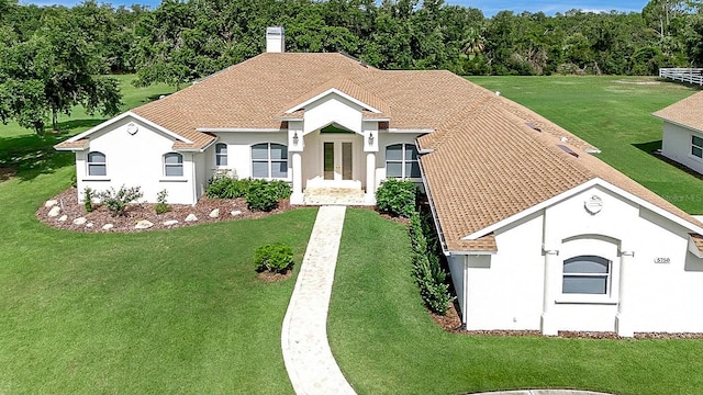 5750 Saddle Oak Trl, Sarasota, FL 34241 - view of front of property featuring a chimney, a front lawn, and stucco siding
