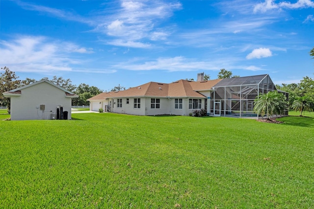 5750 Saddle Oak Trl, Sarasota, FL 34241 - back of property featuring a garage, a lawn, a lanai, and a chimney