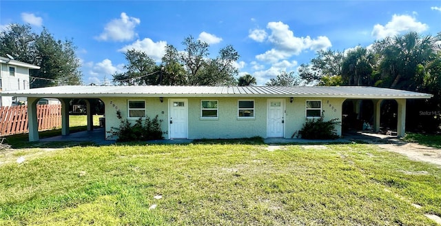 single story home with a front yard and a carport