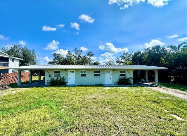 single story home featuring a carport and a front lawn