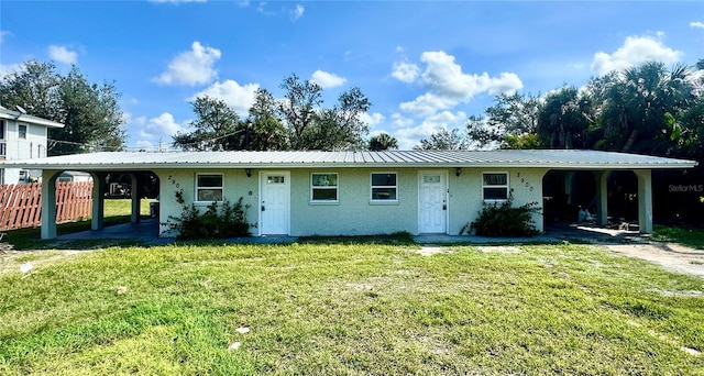 ranch-style house with a front lawn and a carport