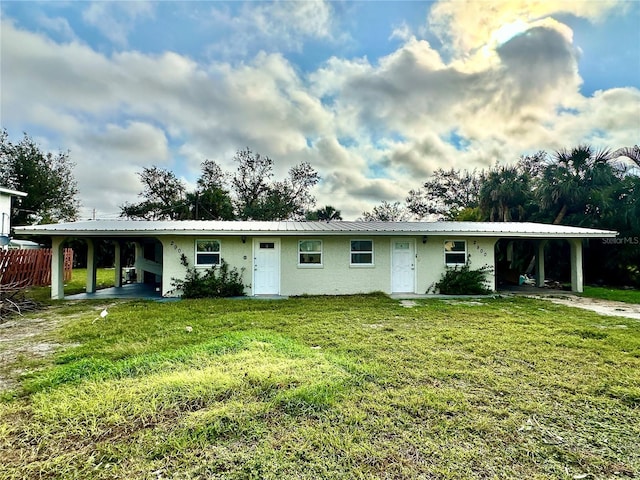 exterior space featuring a yard and a carport