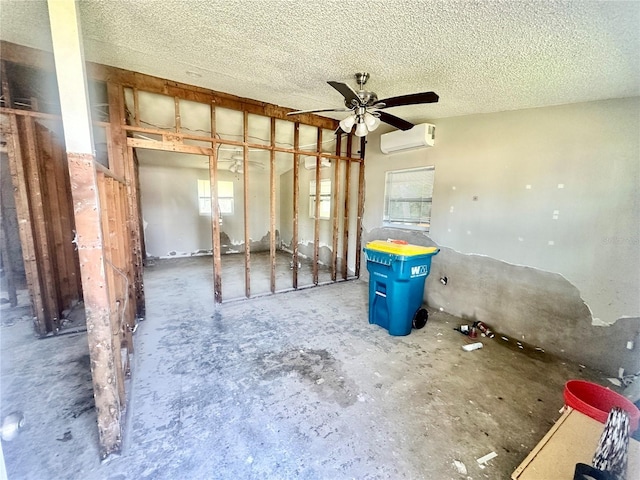 misc room with a wall mounted AC and a textured ceiling