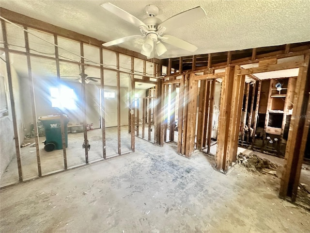 misc room with ceiling fan and a textured ceiling