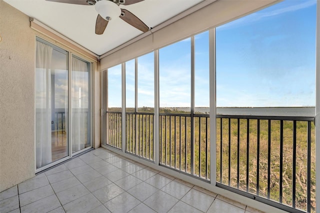 unfurnished sunroom featuring a ceiling fan