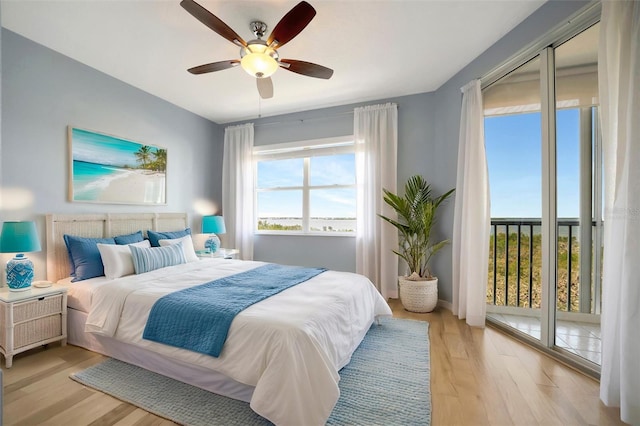 bedroom with ceiling fan, light wood-style flooring, and access to outside