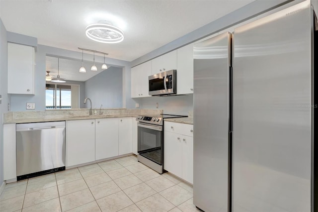 kitchen with stainless steel appliances, light countertops, and white cabinetry