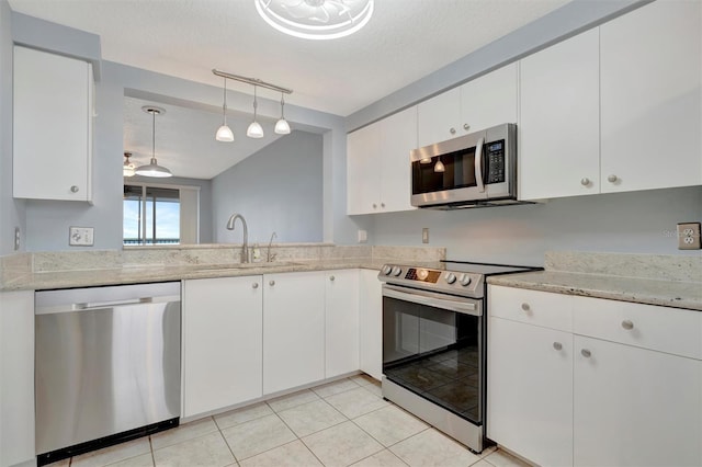 kitchen featuring white cabinets, stainless steel appliances, and a sink