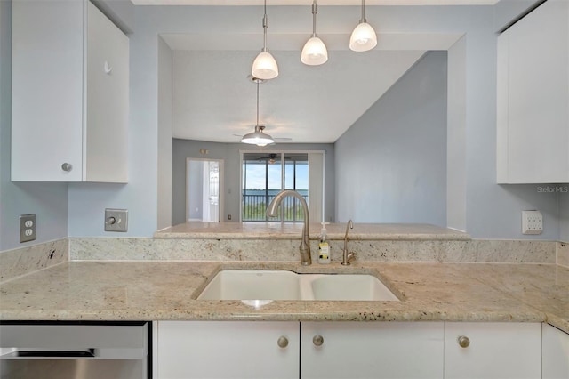 kitchen featuring dishwasher, light stone counters, hanging light fixtures, white cabinetry, and a sink