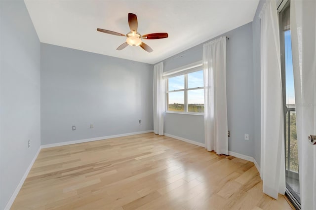 unfurnished room featuring light wood finished floors, baseboards, and a ceiling fan