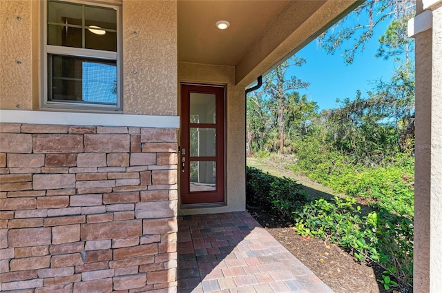 view of exterior entry featuring a patio area