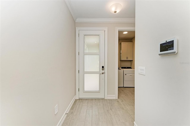 hallway with ornamental molding, washer and dryer, and light wood-type flooring