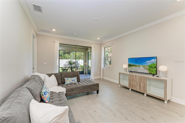 living room with light hardwood / wood-style flooring and ornamental molding