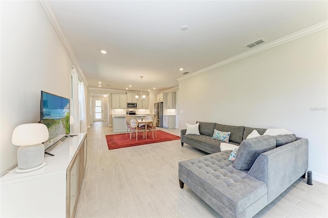 living room with crown molding and light hardwood / wood-style flooring