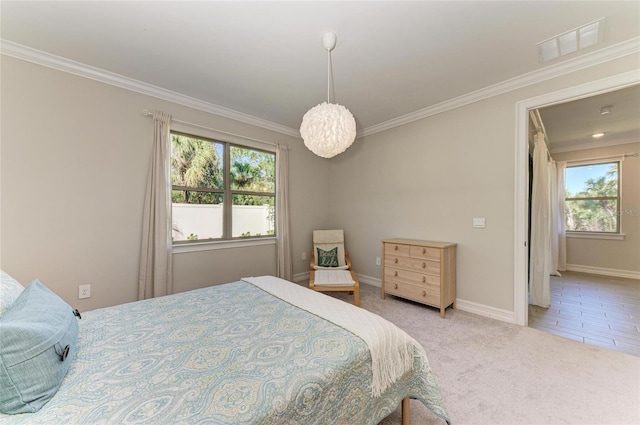 carpeted bedroom featuring ornamental molding and multiple windows