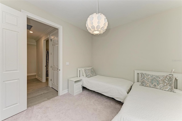 carpeted bedroom featuring an inviting chandelier