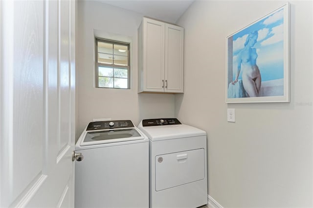 laundry area with cabinets and washing machine and clothes dryer