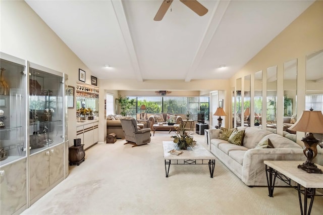 sunroom featuring a ceiling fan, a wealth of natural light, and vaulted ceiling with beams