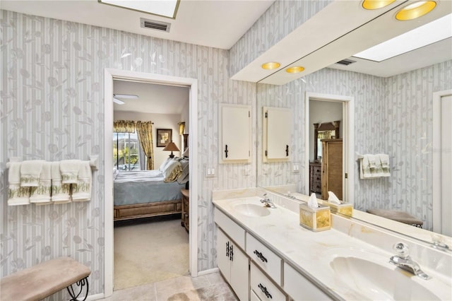 534 Warwick Ln, Venice, FL 34293 - full bathroom featuring double vanity, wallpapered walls, a sink, and ensuite bathroom