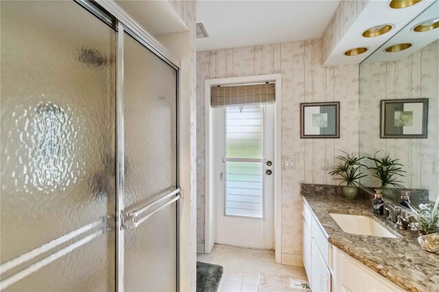 534 Warwick Ln, Venice, FL 34293 - full bathroom with a stall shower, vanity, and wallpapered walls