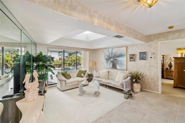 534 Warwick Ln, Venice, FL 34293 - living room with a skylight, visible vents, a textured ceiling, and light tile patterned flooring