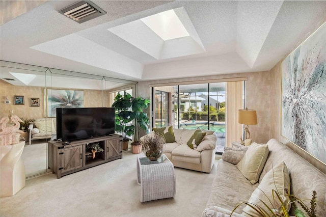 534 Warwick Ln, Venice, FL 34293 - living area with light carpet, a skylight, visible vents, a raised ceiling, and a textured ceiling