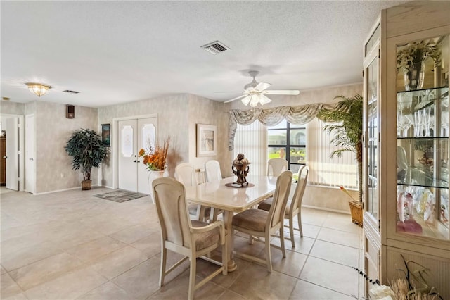 534 Warwick Ln, Venice, FL 34293 - dining space with ceiling fan, visible vents, a textured ceiling, and light tile patterned flooring