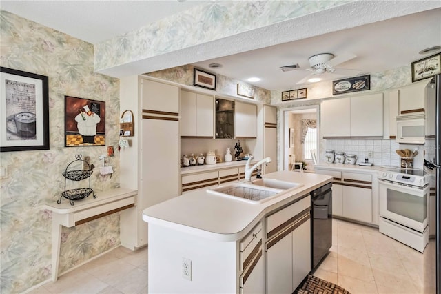 534 Warwick Ln, Venice, FL 34293 - kitchen with white appliances, wallpapered walls, light countertops, and a sink