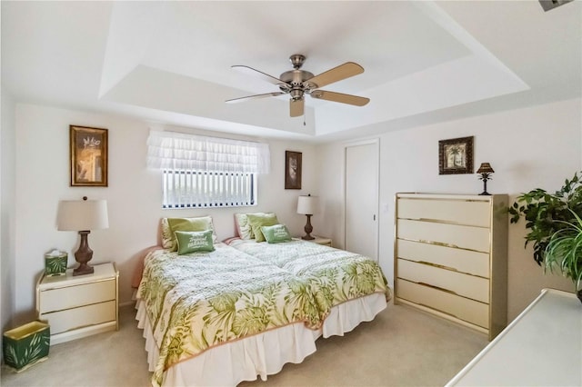 534 Warwick Ln, Venice, FL 34293 - carpeted bedroom with a tray ceiling and a ceiling fan