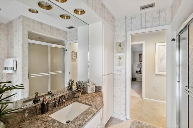 534 Warwick Ln, Venice, FL 34293 - bathroom with tile patterned floors, a shower stall, vanity, and wallpapered walls