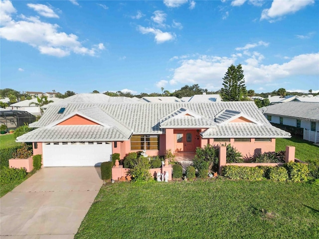 534 Warwick Ln, Venice, FL 34293 - view of front of property featuring a garage, driveway, a tile roof, a front yard, and stucco siding