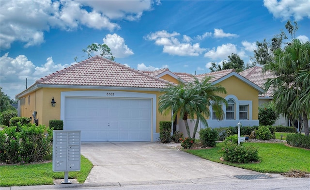 view of front of property with driveway, a tile roof, a front lawn, and stucco siding