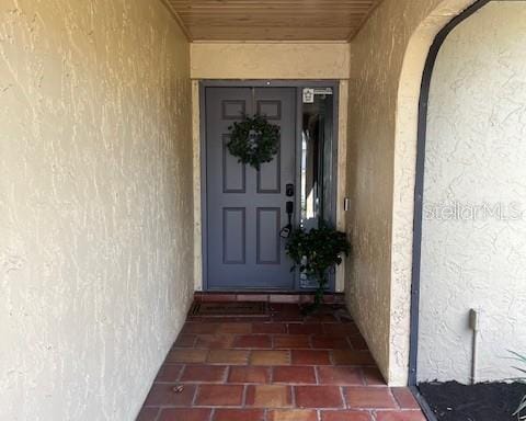 view of exterior entry featuring stucco siding