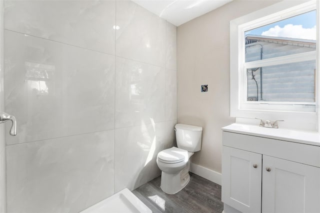full bath with baseboards, vanity, toilet, and wood finished floors