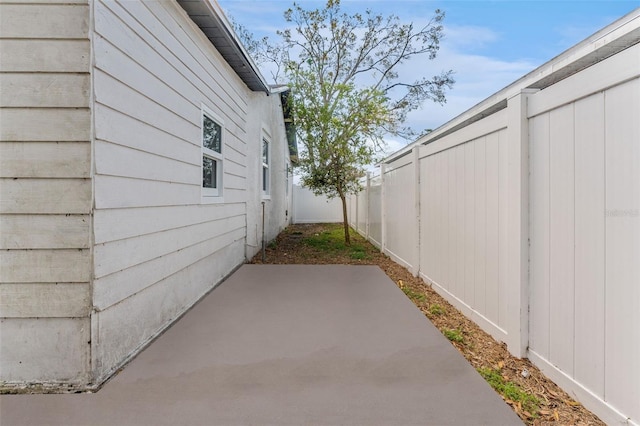 view of home's exterior with a fenced backyard and a patio