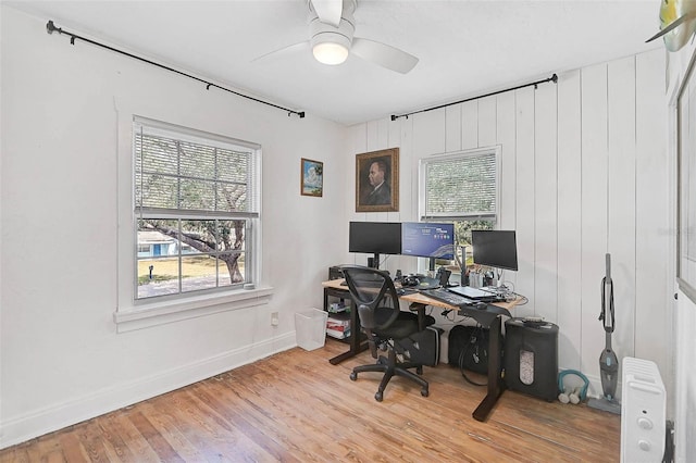 office with ceiling fan, plenty of natural light, and light hardwood / wood-style floors