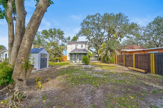 view of yard featuring a shed and a sunroom