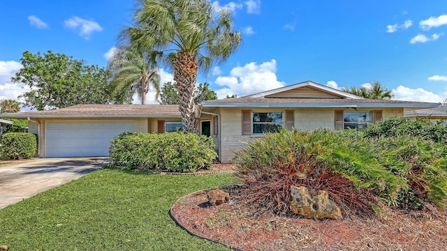 ranch-style home with a garage and a front yard