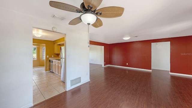 spare room featuring light hardwood / wood-style floors and ceiling fan