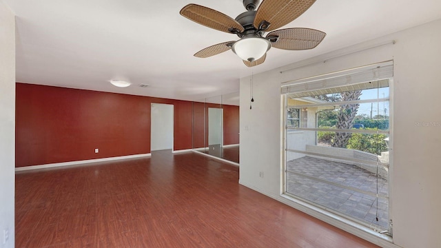 empty room with ceiling fan and dark hardwood / wood-style floors