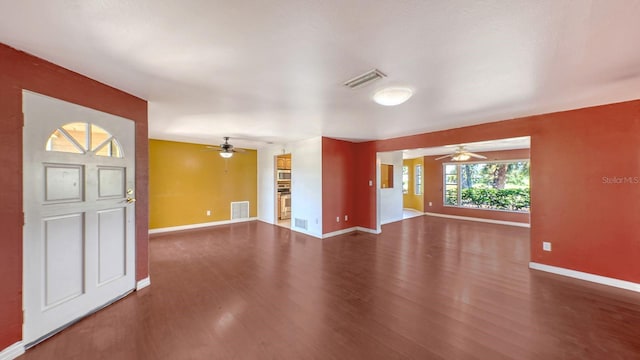 unfurnished living room featuring dark hardwood / wood-style floors and ceiling fan