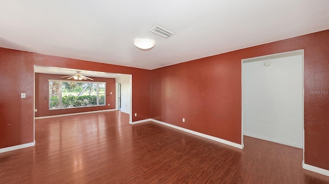 spare room featuring dark wood-type flooring and ceiling fan