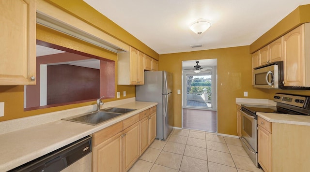 kitchen with sink, light tile patterned floors, ceiling fan, stainless steel appliances, and light brown cabinets