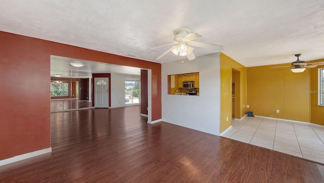 spare room featuring wood-type flooring, a textured ceiling, and ceiling fan