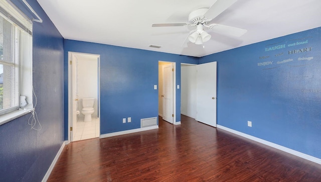 unfurnished bedroom featuring ceiling fan, connected bathroom, and dark hardwood / wood-style floors