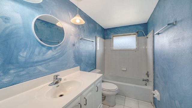 full bathroom featuring vanity, tiled shower / bath combo, tile patterned floors, and toilet