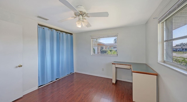 spare room with ceiling fan and dark hardwood / wood-style flooring