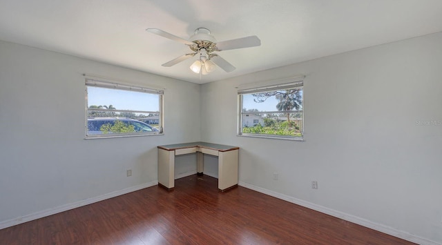 spare room with ceiling fan, plenty of natural light, and dark hardwood / wood-style flooring