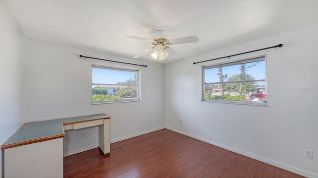 spare room featuring dark hardwood / wood-style flooring and ceiling fan